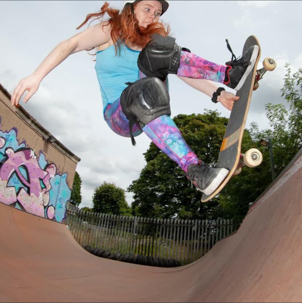 Rebecca Davies mid-air on a mini ramp